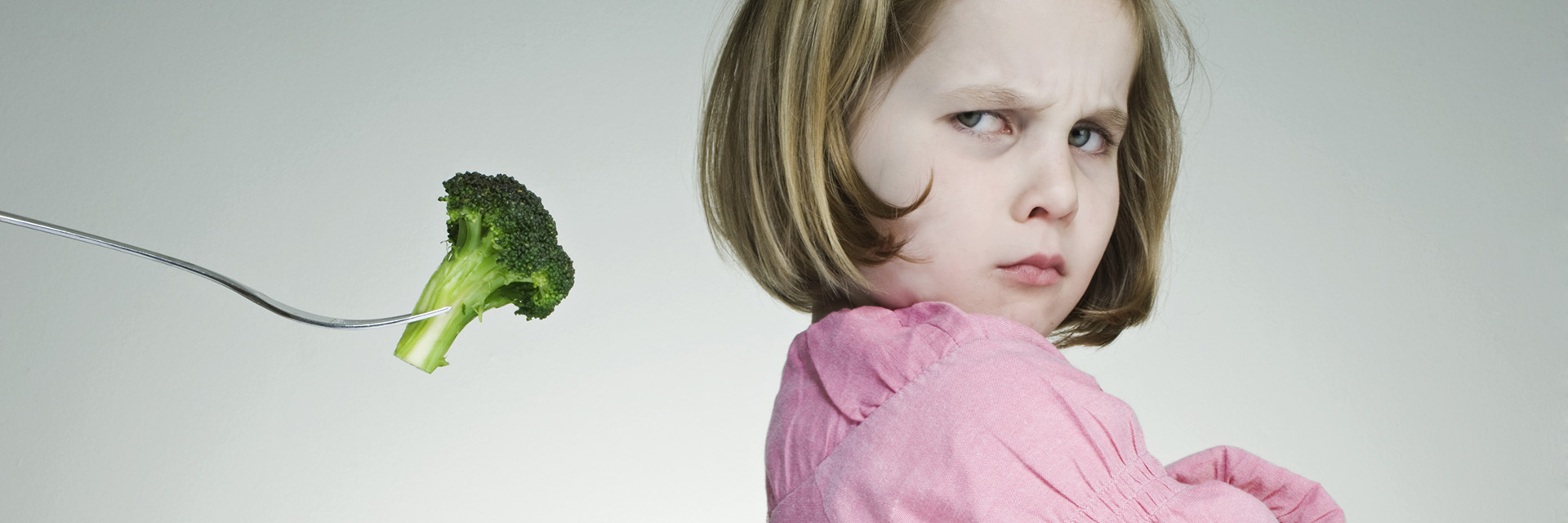 Trying To Encourage a Young Girl to Eat Her Greens