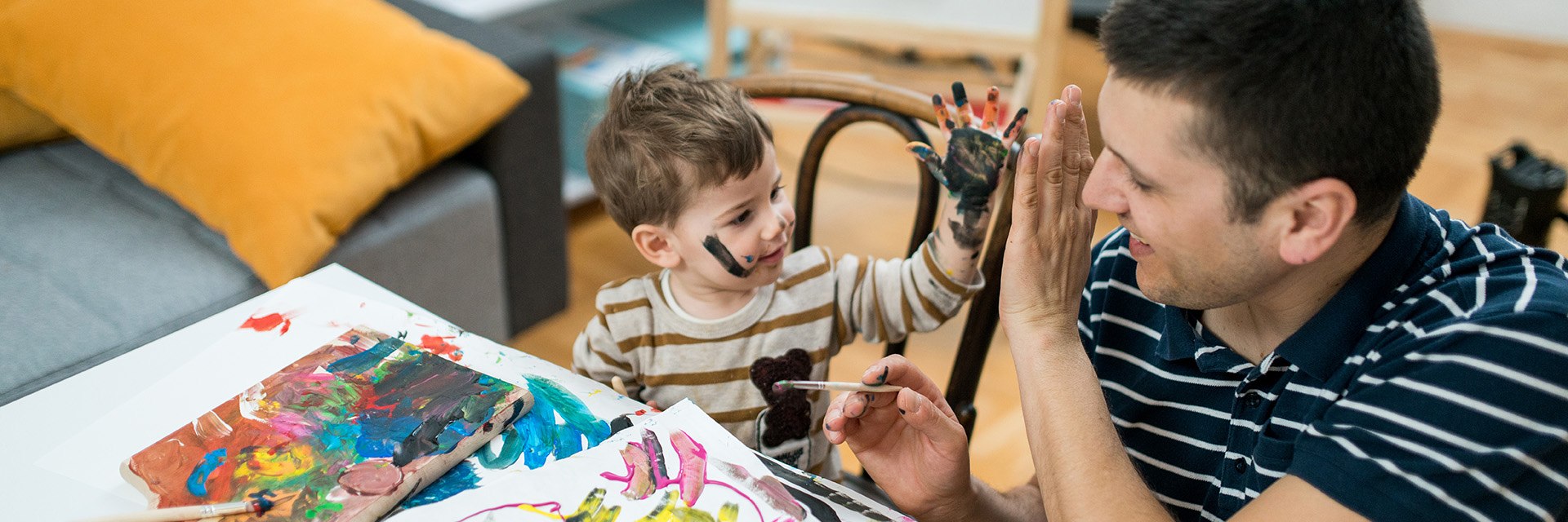 Baby boy painting with watercolors